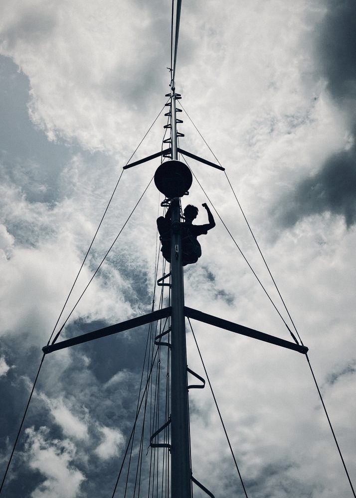 Crew member at the top of a mast